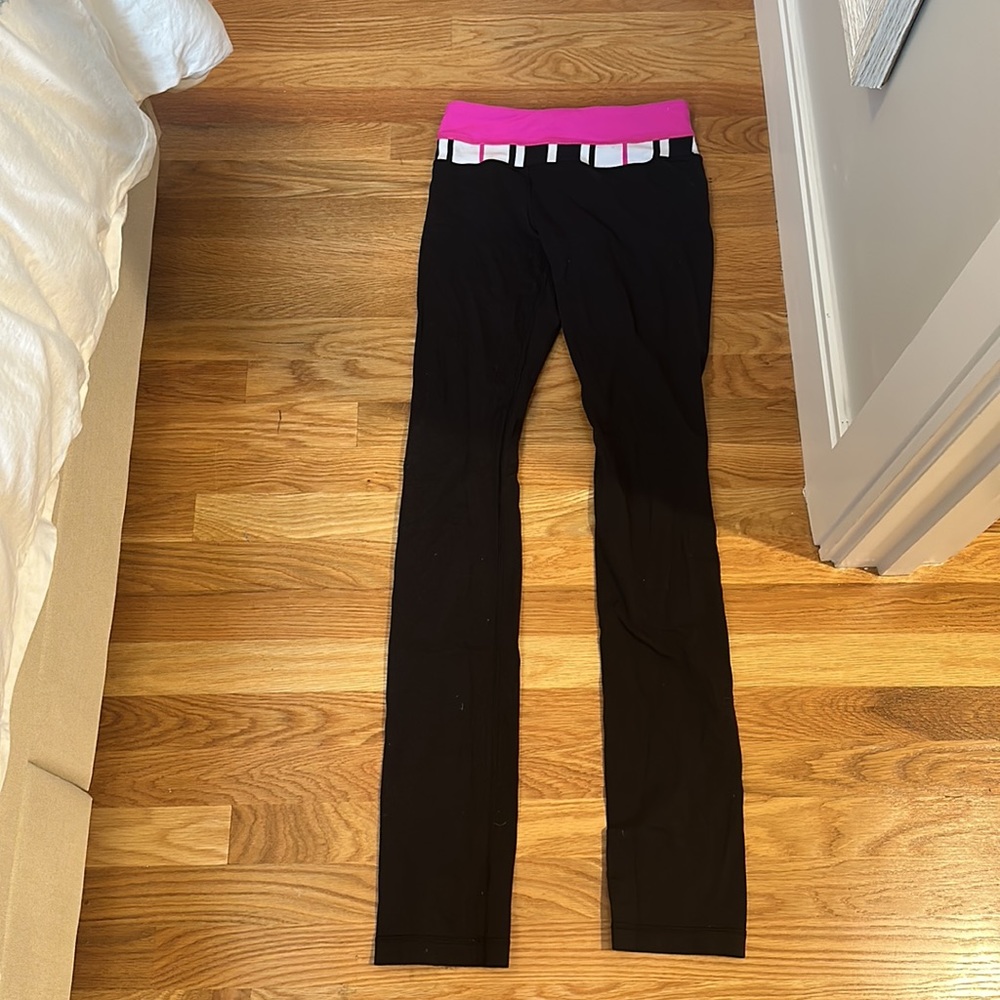Straight leg black Lululemon leggings with pink waist band